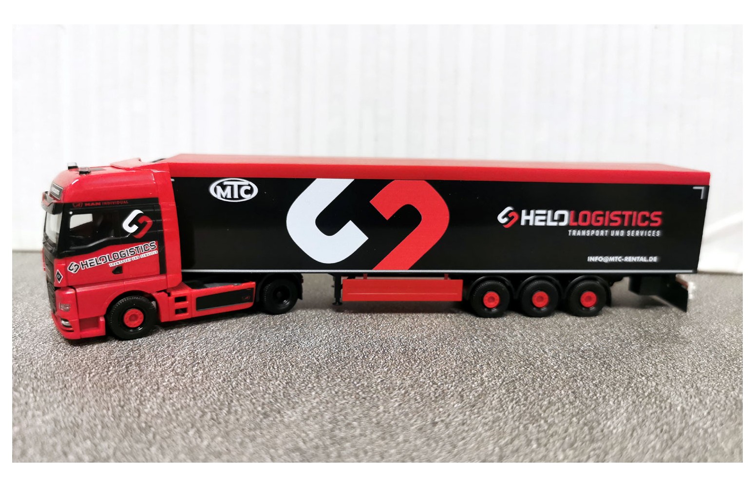 HERPA 319324 MAN TGX GX con semirimorchio "Helo-Logistik" - 1:87